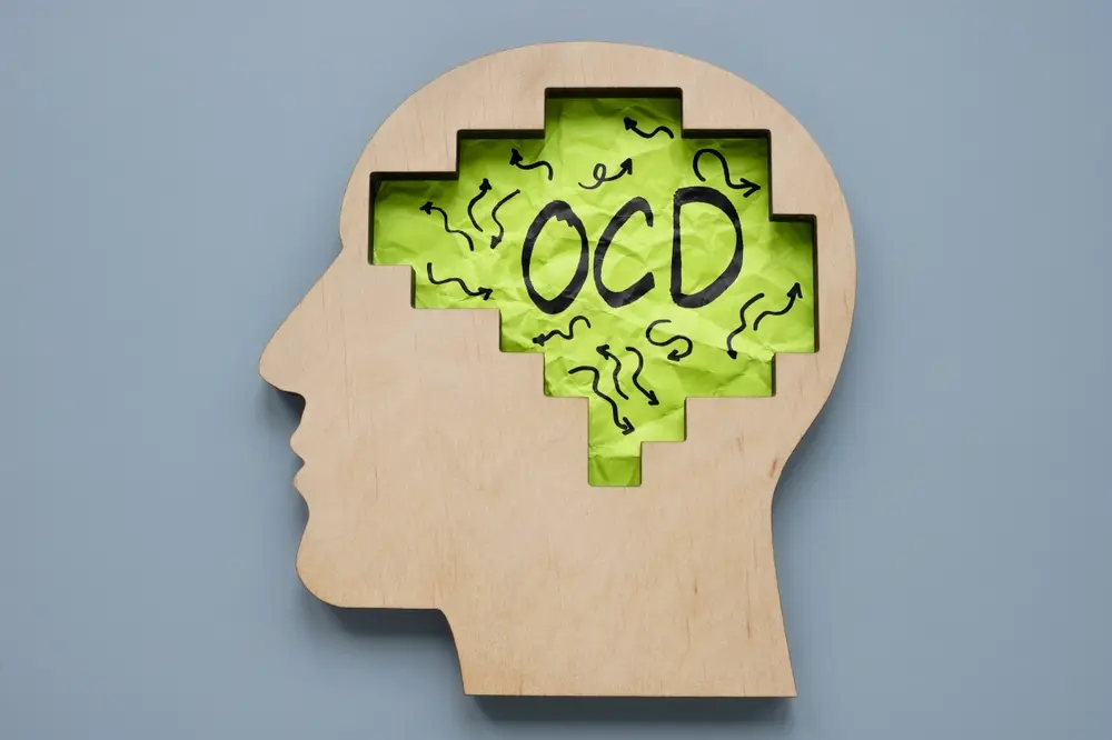 Illustration of a brain with OCD text representing obsessive compulsive disorder